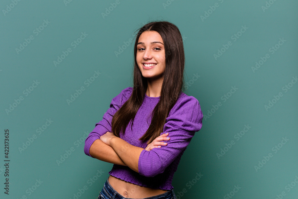 Young Indian woman isolated on blue background happy, smiling and cheerful. Young Indian woman isolated on blue background happy, smiling and cheerful.