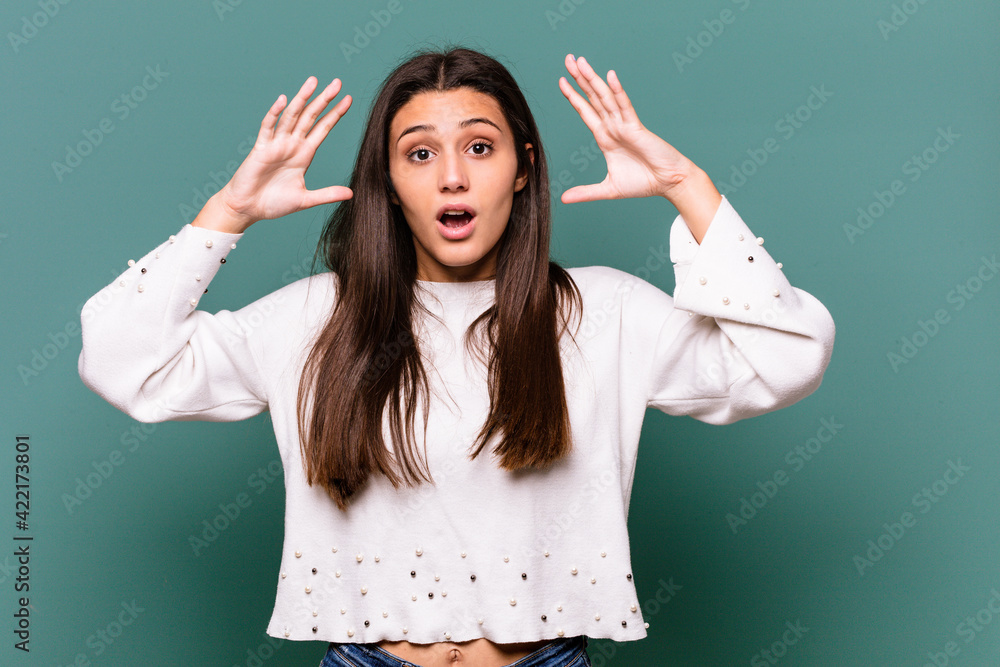 Young Indian woman isolated on blue background celebrating a victory or success, he is surprised and shocked. Young Indian woman isolated on blue background celebrating a victory or success, he is surprised and shocked.