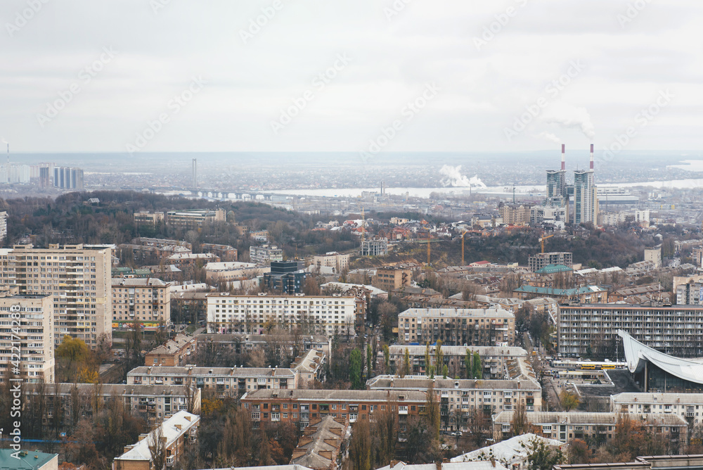 Urban view from rooftops of Kyiv city, Ukraine. Industrial landscape from above on moody day