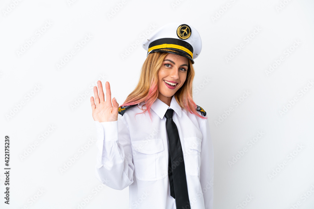 Airplane pilot over isolated white background saluting with hand with happy expression Airplane pilot over isolated white background saluting with hand with happy expression