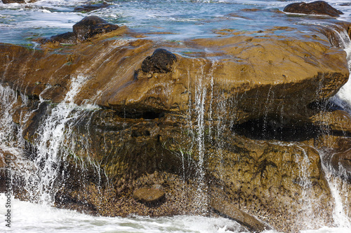 Ocean water flowing over rocks