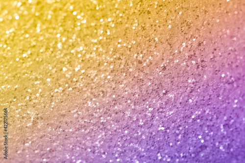 Sparkling abstract yellow and magenta background. Bright gradient glitter with blur effect. Holiday abstraction close-up © Yana Mirta