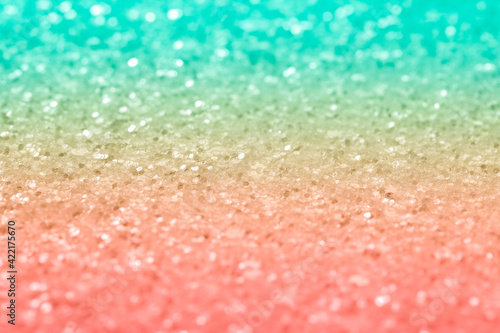 Sparkling abstract pink and turquoise background. Bright gradient glitter with blur, close-up abstraction