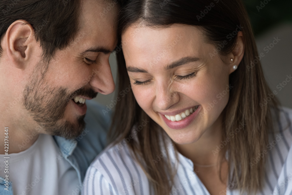 Close up happy man and woman touching foreheads, expressing love and care, chatting, having fun, smiling young loving couple, family enjoying tender moment together, romantic date concept Close up happy man and woman touching foreheads, expressing love and care, chatting, having fun, smiling young loving couple, family enjoying tender moment together, romantic date concept