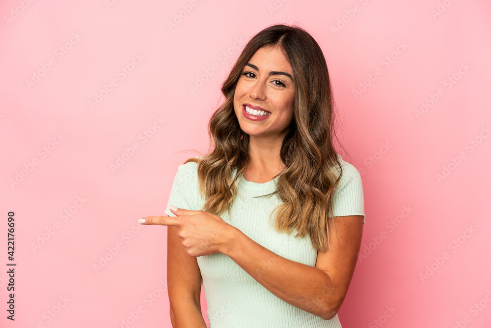 Young caucasian woman isolated smiling and pointing aside, showing something at blank space. Young caucasian woman isolated smiling and pointing aside, showing something at blank space.