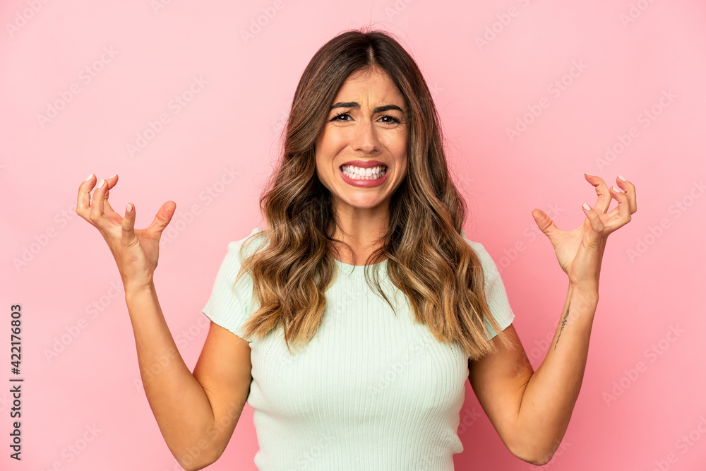 Young caucasian woman isolated screaming with rage. Young caucasian woman isolated screaming with rage.