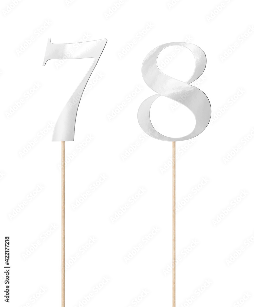 Shiny silver topper paper cake numbers signs (seven, eight) on stick isolated on white background. Clipping path included. Shiny silver topper paper cake numbers signs (seven, eight) on stick isolated on white background. Clipping path included.