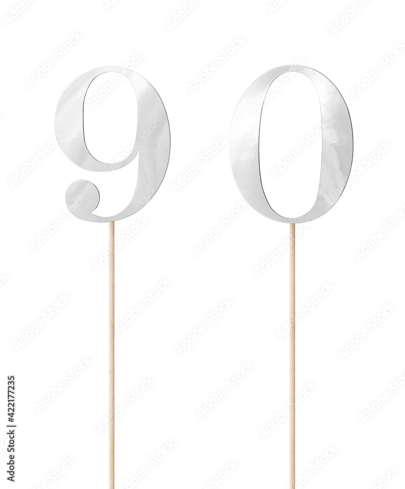 Shiny silver topper paper cake numbers signs (nine, zero) on stick isolated on white background. Clipping path included. Shiny silver topper paper cake numbers signs (nine, zero) on stick isolated on white background. Clipping path included.