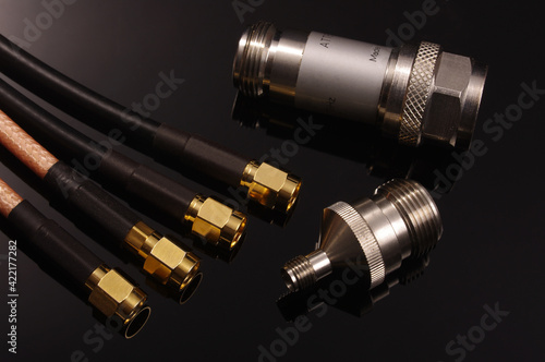 RF coaxial cables, attenuator and adapter isolated on black photo