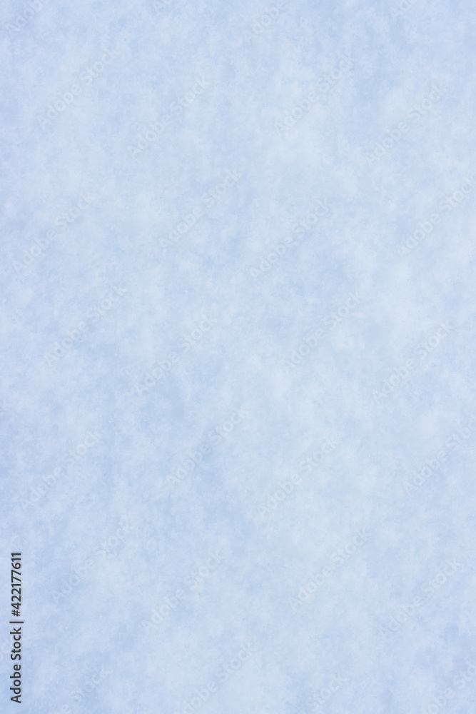 Natural snow texture. Smooth surface of clean fresh snow. Snowy ground. Winter background with snow patterns. Perfect for Christmas and New Year design. Closeup top view. Soft blurred background.