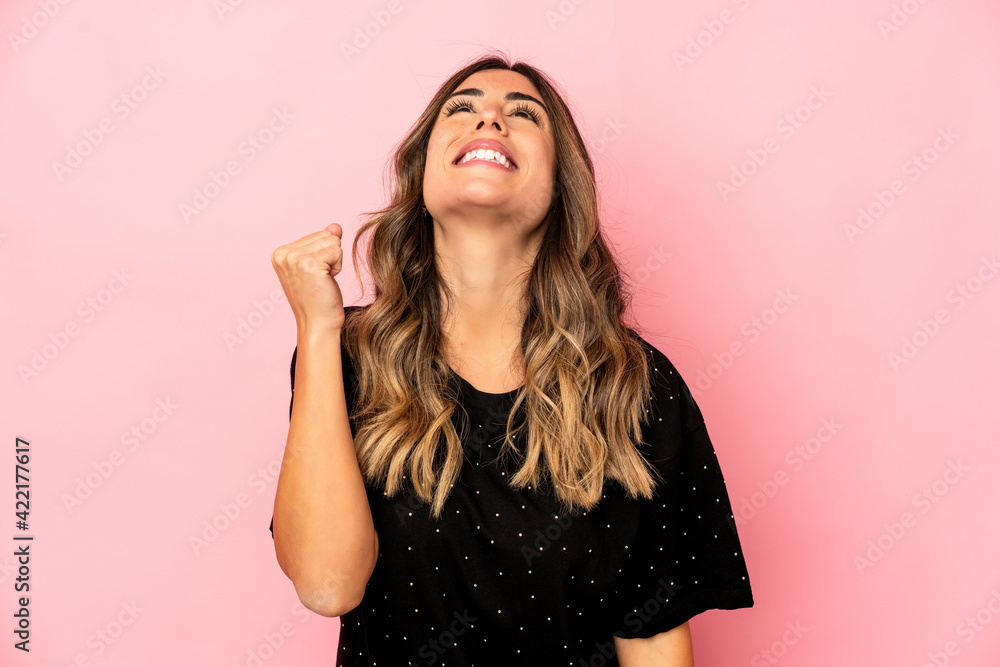 Young caucasian woman isolated celebrating a victory, passion and enthusiasm, happy expression. Young caucasian woman isolated celebrating a victory, passion and enthusiasm, happy expression.