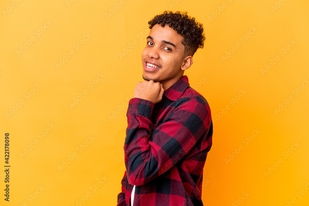 Young african american curly man isolated on purple smiling happy and confident, touching chin with hand. Young african american curly man isolated on purple smiling happy and confident, touching chin with hand.