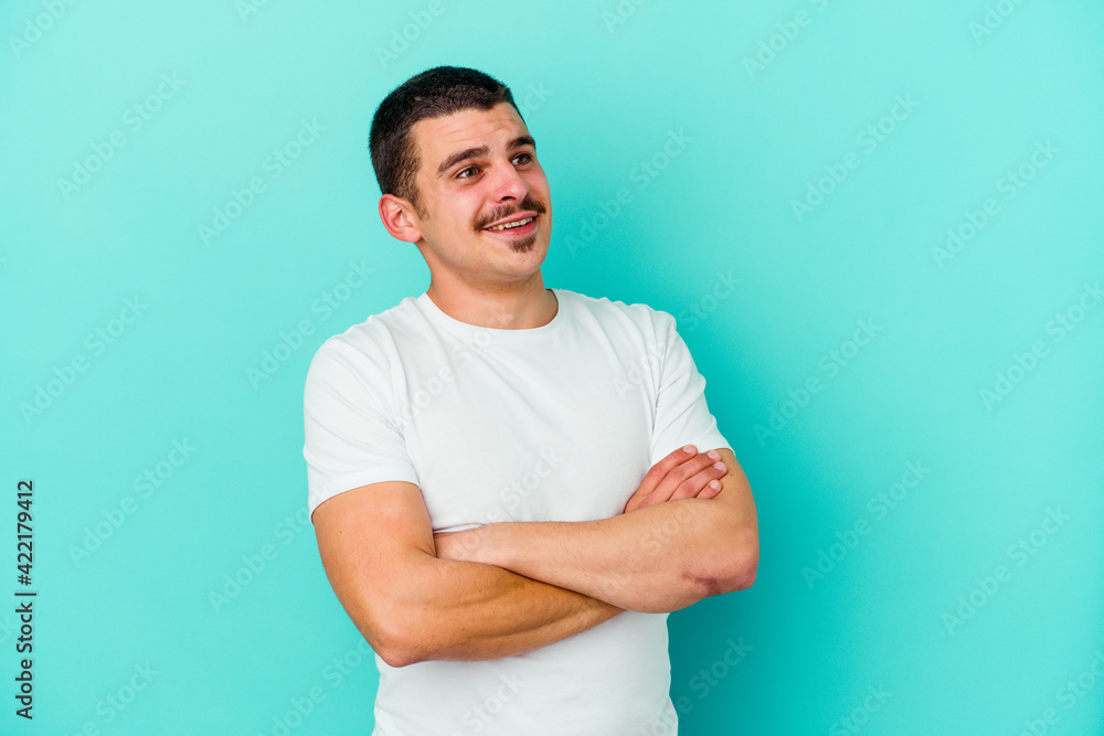Young caucasian man isolated on blue background dreaming of achieving goals and purposes Young caucasian man isolated on blue background dreaming of achieving goals and purposes