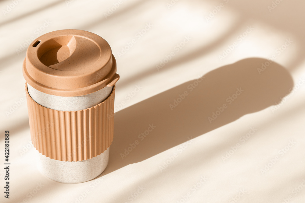 Reusable cup, biodegradable travel plastic coffee mug for take away.  Sustainable bamboo eco friendly cup on natural shadow beige background.  Zero waste, sustainability concept. Ban single use plastic Photos | Adobe  Stock