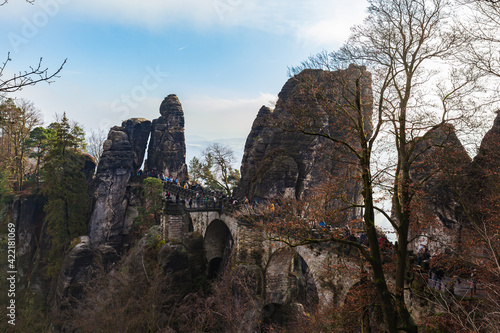 Close view of Bastei Bridge and sandstone rock mountains in Saxon Switzerland National Park on a winter day with blue sky, Saxony, Germany