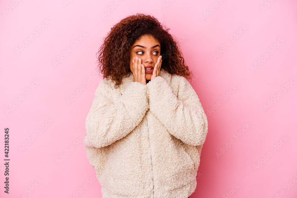 Young african american woman isolated on pink background scared and afraid. Young african american woman isolated on pink background scared and afraid.
