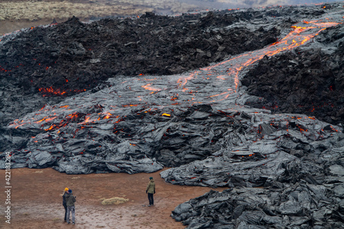 GELDINGADALIR, ICELAND - MARCH 21, 2021: A small volcanic eruption started at the Reykjanes peninsula. The event has attracted thousands of visitors who have braved a daring hike to the crater.