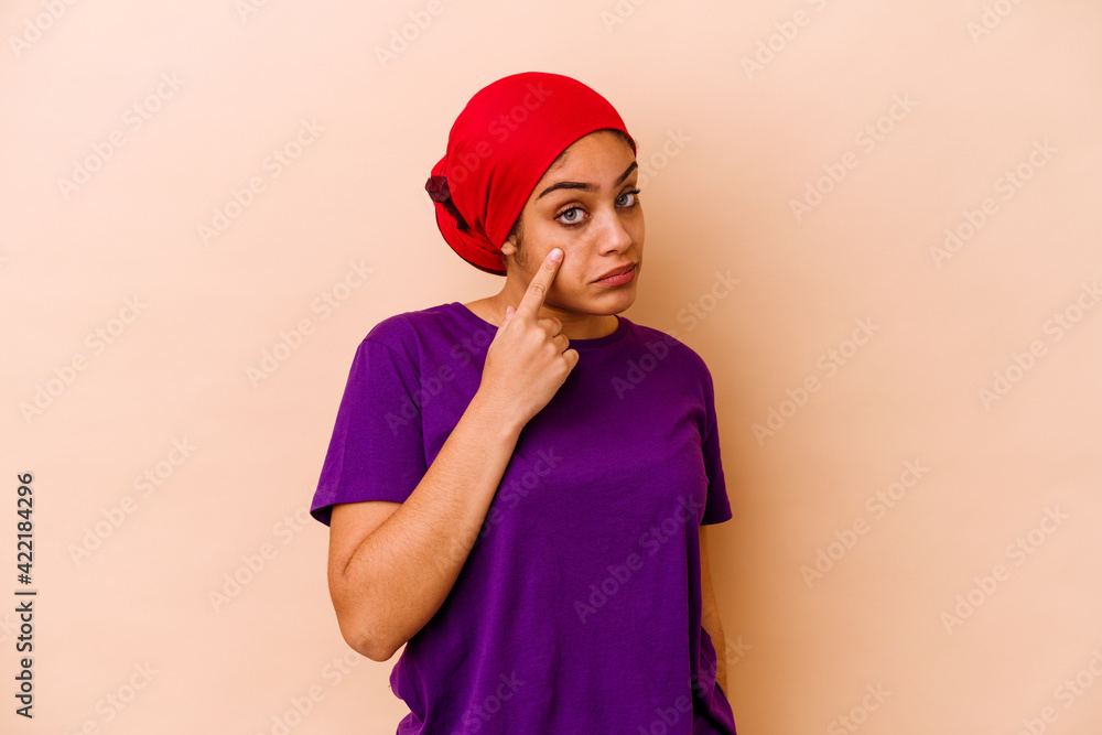 Young african american woman isolated on beige background crying, unhappy with something, agony and confusion concept.