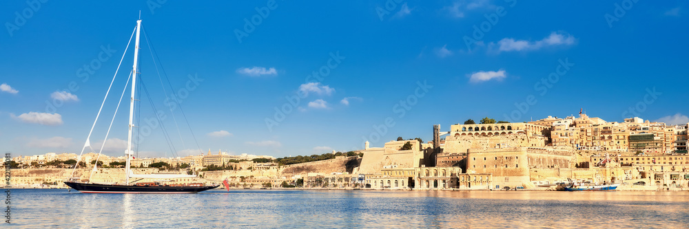 Sailing ship enters Grand Valetta bay on a bright day