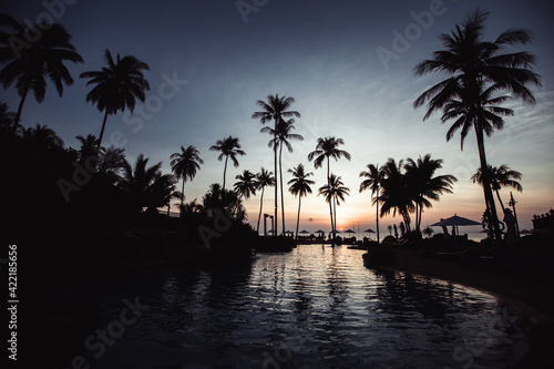 Silhouette of asian tropical beach during an surrealistic sunset.