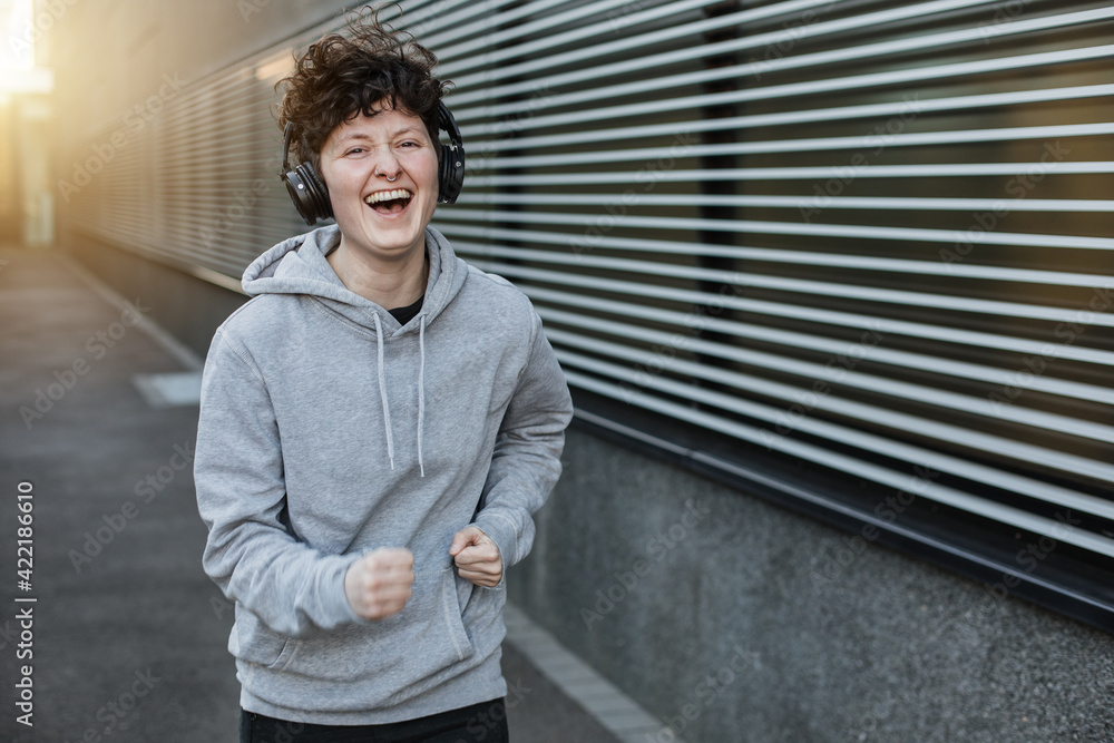 Jogger laughs a lot and is happy. Sporty person is motivated. Jogger laughs a lot and is happy. Sporty person is motivated.