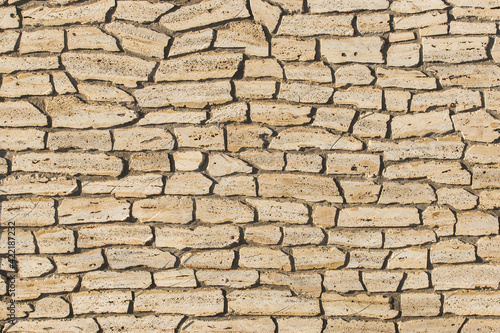 Sand color stone or brick wall, modern texture background