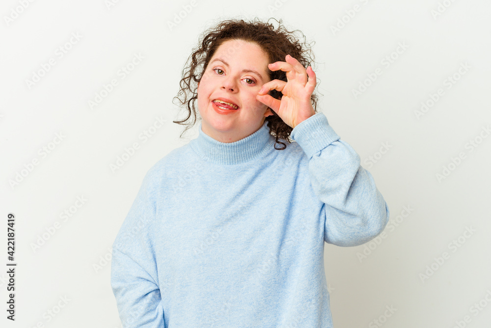 Woman with Down syndrome isolated excited keeping ok gesture on eye. Woman with Down syndrome isolated excited keeping ok gesture on eye.