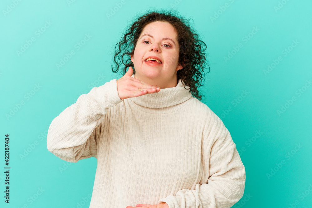 Obraz premium Woman with Down syndrome isolated holding something with both hands, product presentation.