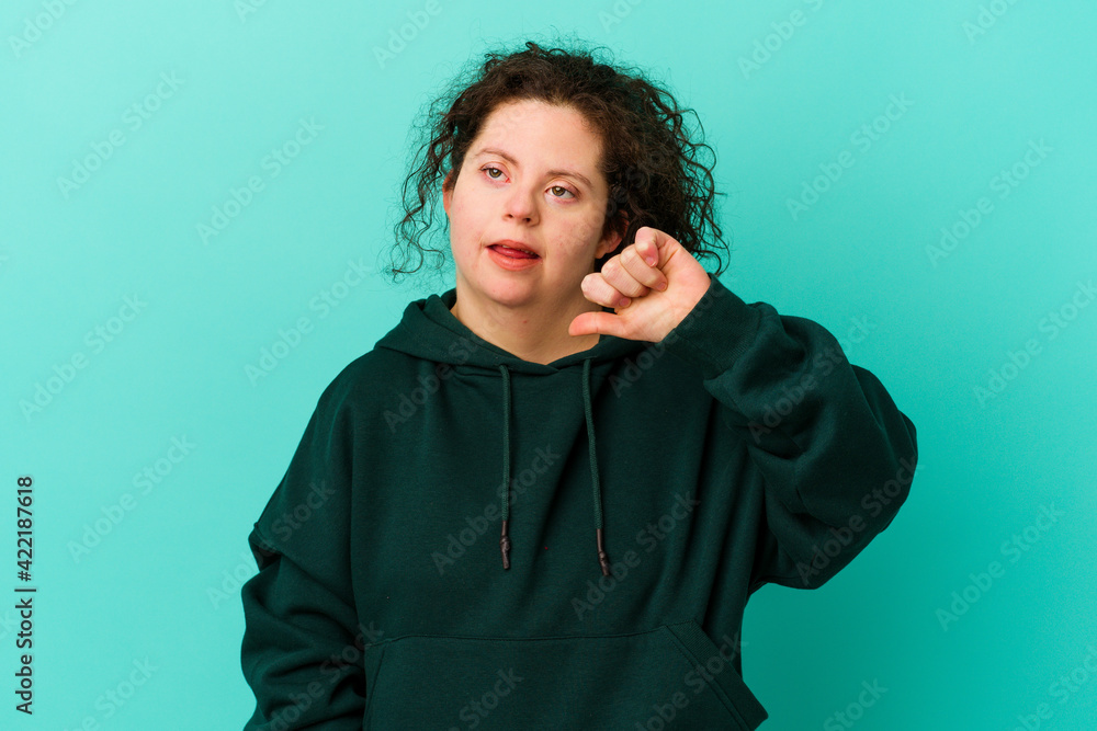 Woman with Down syndrome isolated showing thumb down and expressing dislike. Woman with Down syndrome isolated showing thumb down and expressing dislike.
