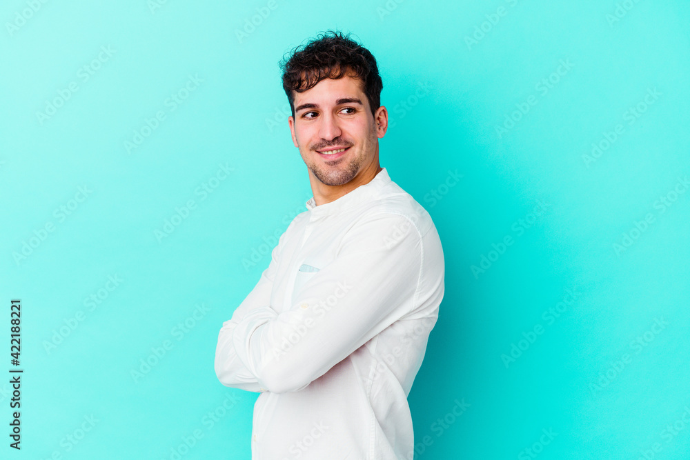 Young caucasian man isolated on blue background laughing and having fun. Young caucasian man isolated on blue background laughing and having fun.