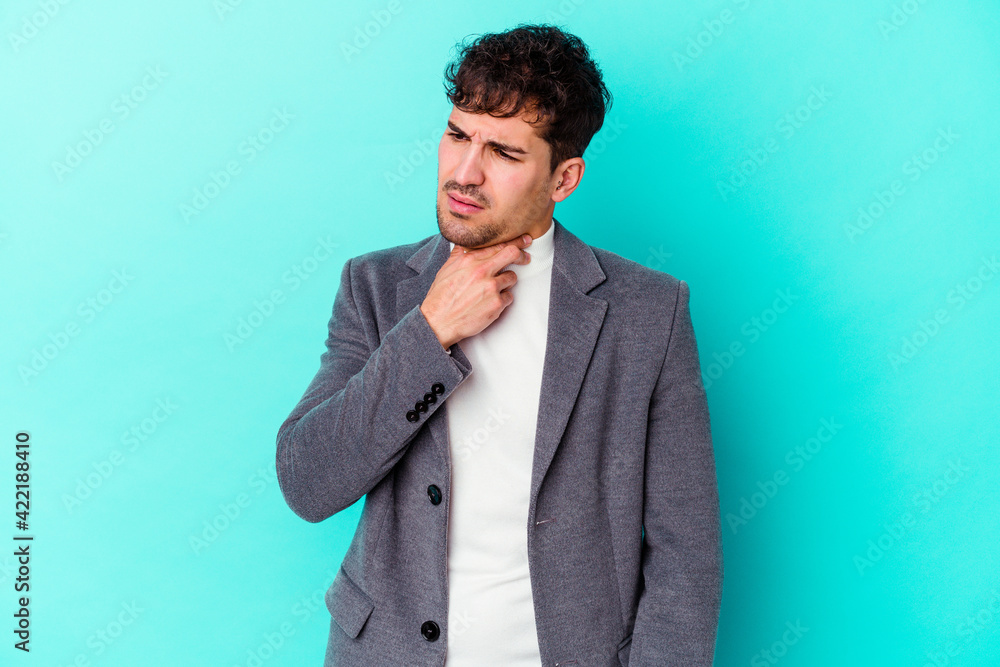 Young caucasian man isolated on blue background suffers pain in throat due a virus or infection. Young caucasian man isolated on blue background suffers pain in throat due a virus or infection.