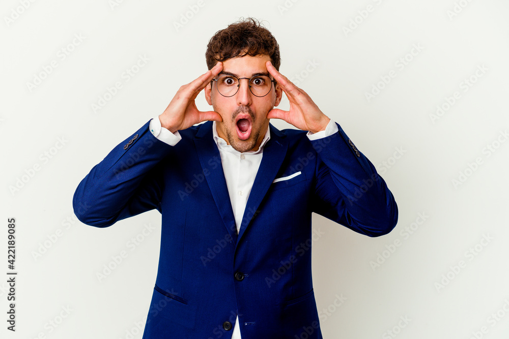 Young business caucasian man isolated on white background having fun covering half of face with palm. Young business caucasian man isolated on white background having fun covering half of face with palm.