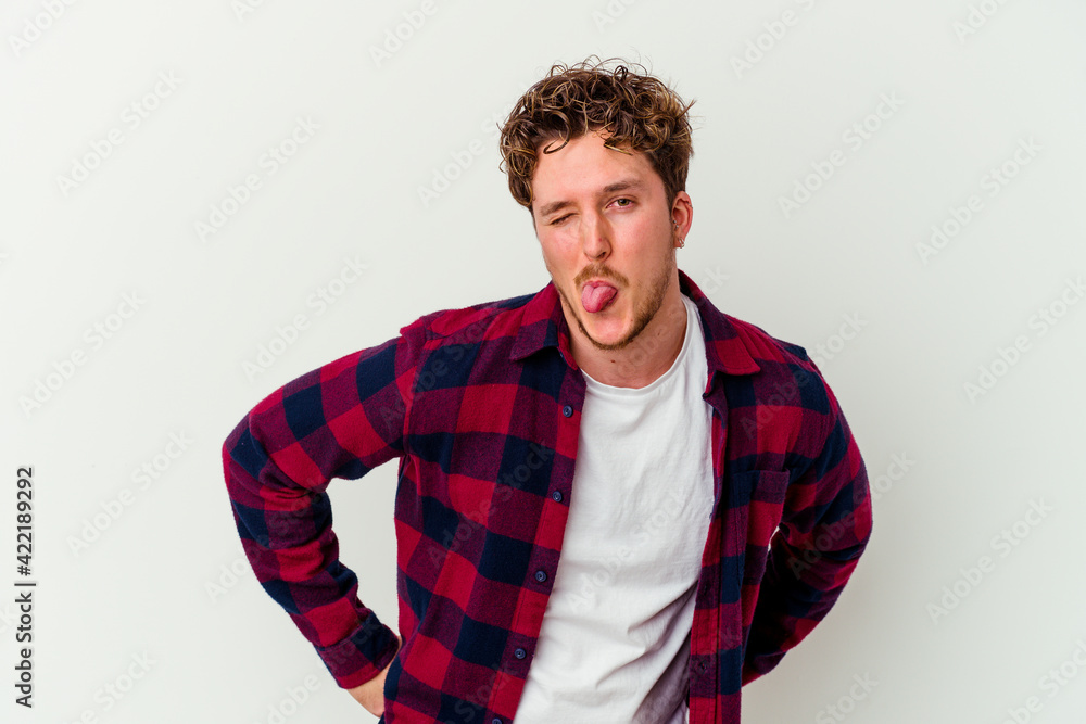 Young caucasian man isolated on white background funny and friendly sticking out tongue. Young caucasian man isolated on white background funny and friendly sticking out tongue.