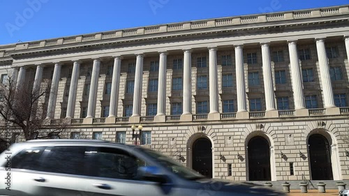 The Internal Revenue Service Building, headquarters of the IRS, in Washington, D.C. seen from Constitution Avenue NW during the day in early spring. The wide-angle camera view pans from left to right. photo