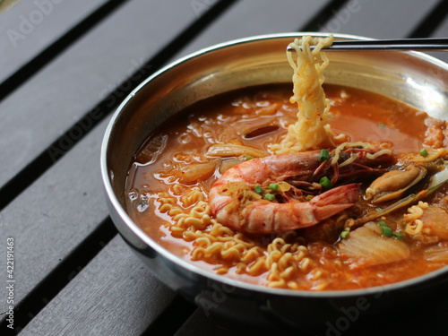 Kimchi Ramyeon, Seafood Ramen, Korean Instant noodle. Spicy Korean Noodle Soup. Kimchi Ramen on Stainless Steel Bowl. photo