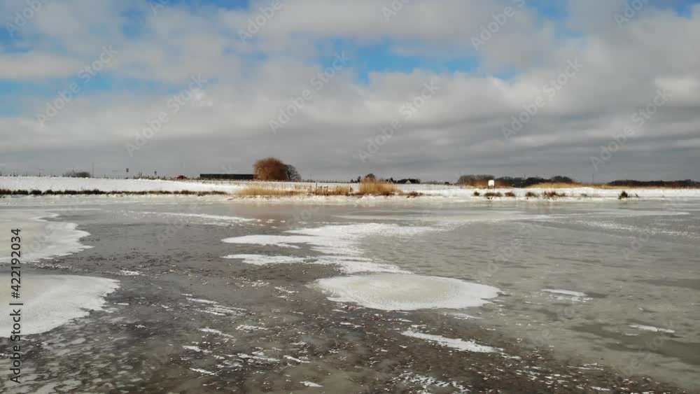 Cloudscape Over Frozen Wetland At Crezeepolder Near Ridderkerk In South Holland, Netherlands. - Low Aerial Shot Cloudscape Over Frozen Wetland At Crezeepolder Near Ridderkerk In South Holland, Netherlands. - Low Aerial Shot