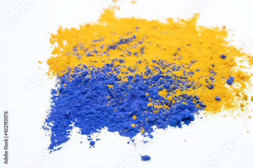 Multi-colored abstract powder explosion on white background.