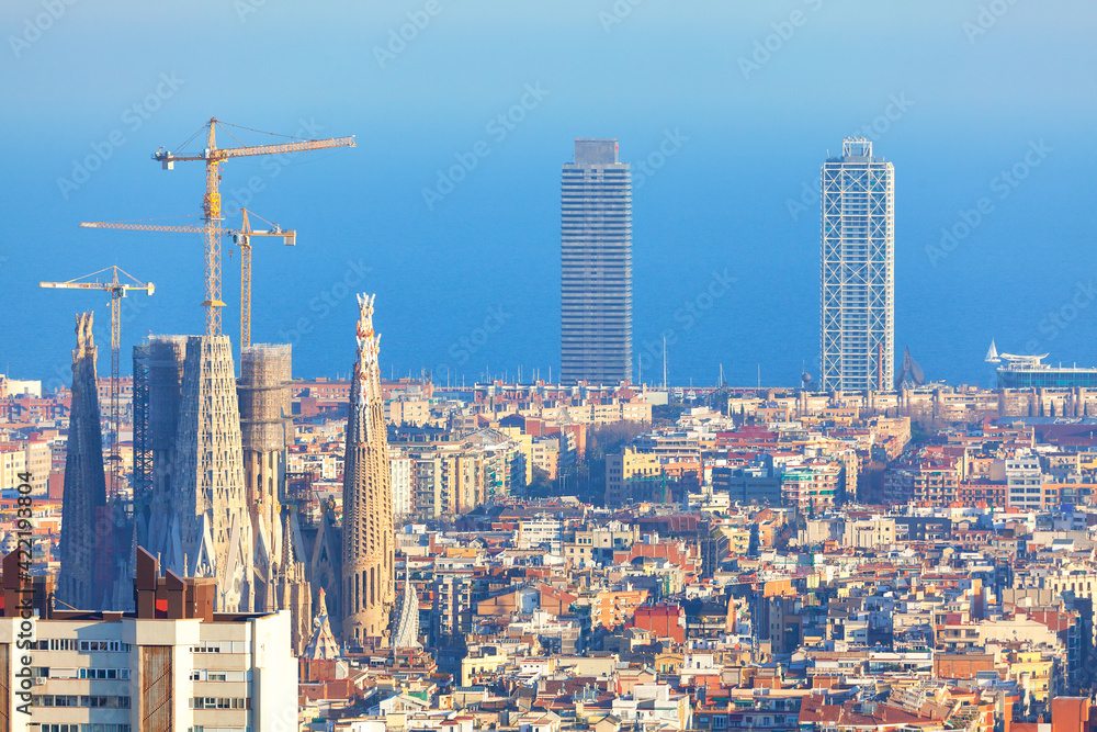 Awesome Barcelona Cityscape . Gracia Famous catalonian district in Barcelona . Cathedral with construction cranes 