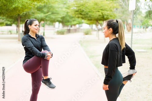 Beautiful women in their 30s doing stretching exercises © AntonioDiaz