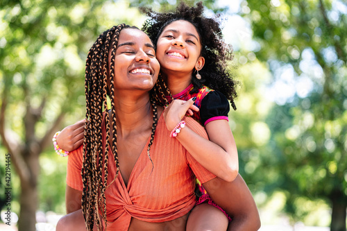 Mother and daughter enjoying a day at the park.