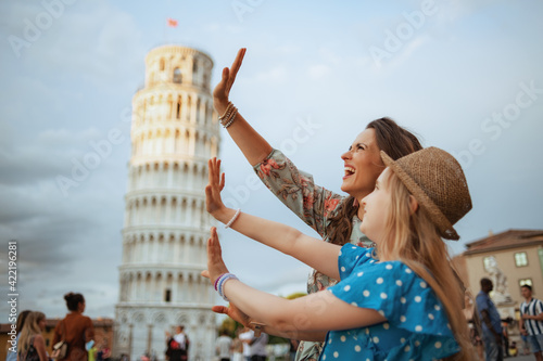 Vászonkép happy trendy family posing at Leaning Tower in Pisa, Italy
