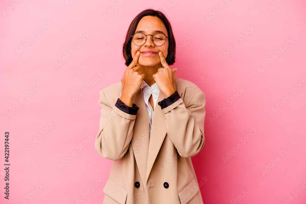 Young business mixed race woman isolated on pink background doubting between two options. Young business mixed race woman isolated on pink background doubting between two options.