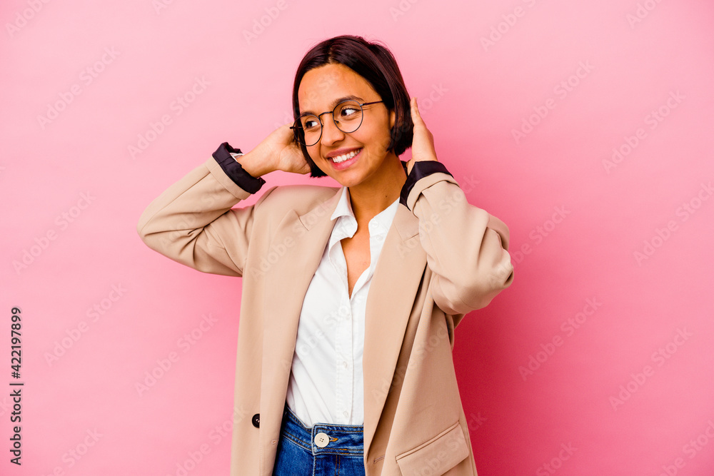 Young business mixed race woman isolated on pink background feeling confident, with hands behind the head. Young business mixed race woman isolated on pink background feeling confident, with hands behind the head.