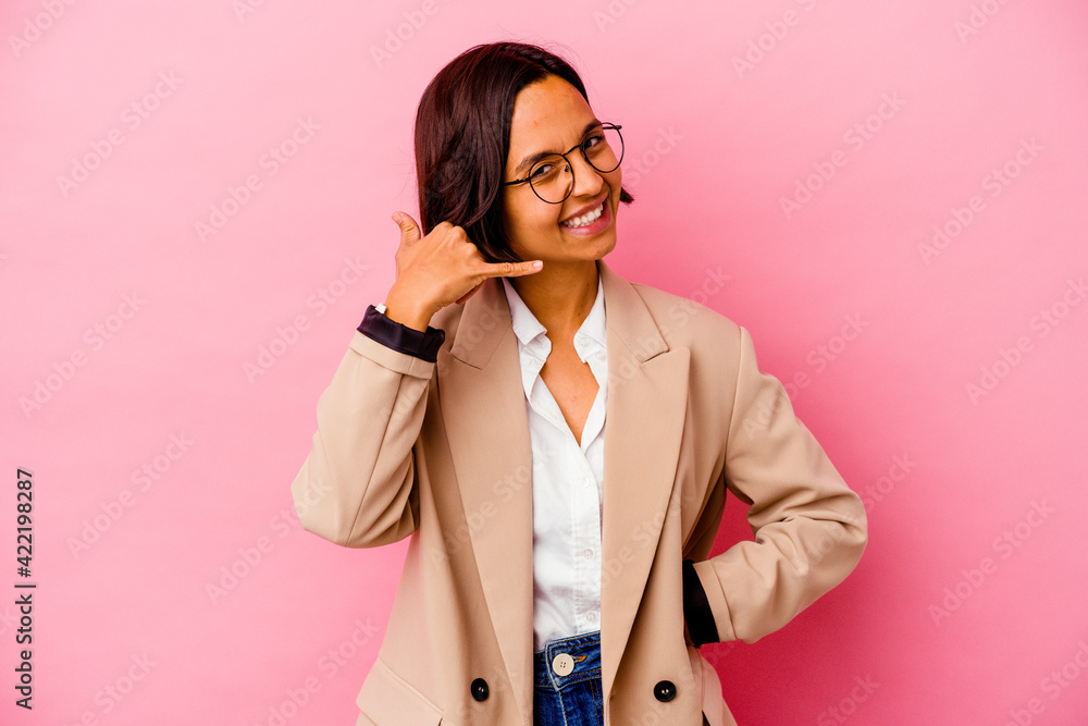 Young business mixed race woman isolated on pink background showing a mobile phone call gesture with fingers.