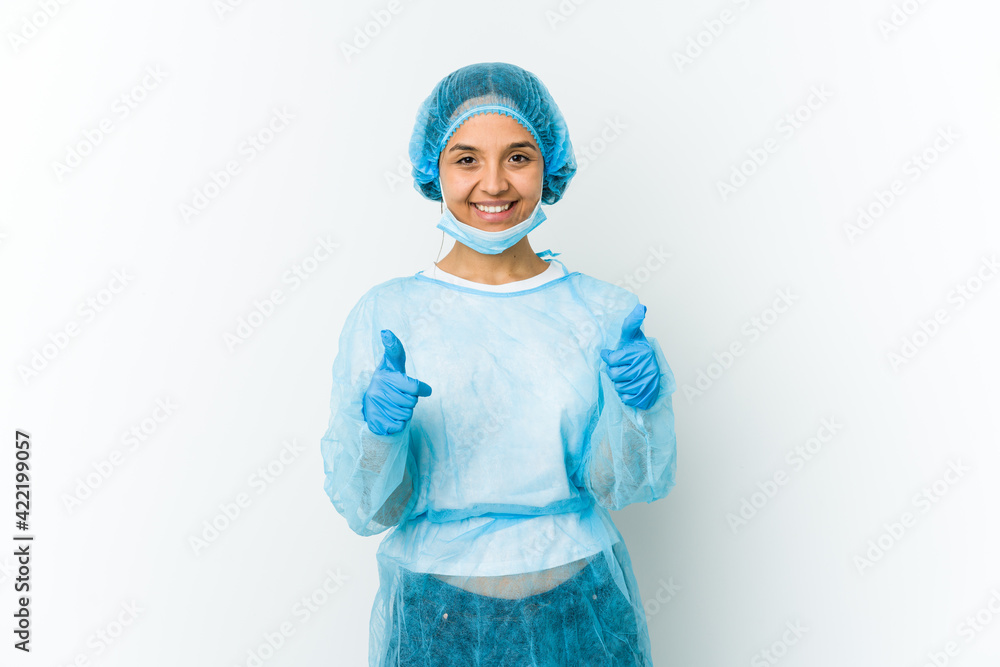 Young surgeon latin woman isolated on white background with thumbs ups, cheers about something, support and respect concept. Young surgeon latin woman isolated on white background with thumbs ups, cheers about something, support and respect concept.