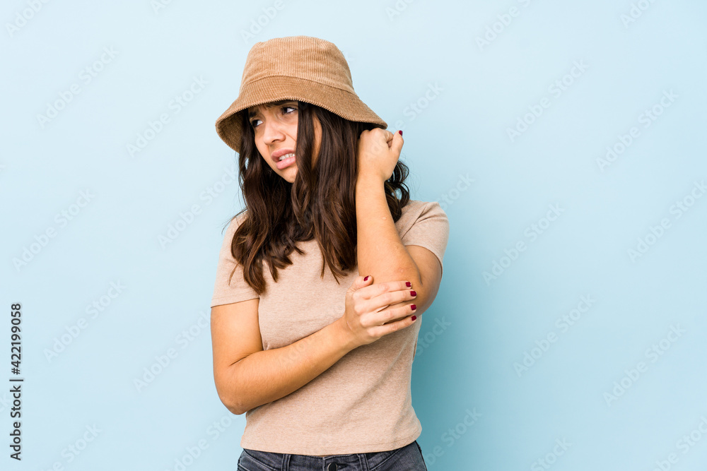 Young mixed race hispanic woman isolated massaging elbow, suffering after a bad movement. Young mixed race hispanic woman isolated massaging elbow, suffering after a bad movement.