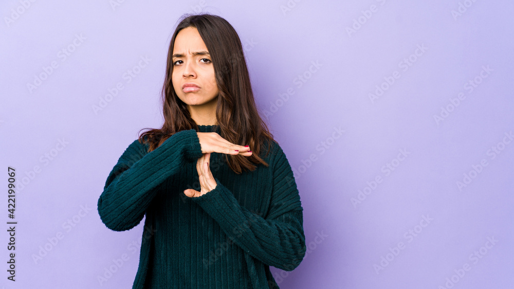 Young mixed race hispanic woman isolated showing a timeout gesture. Young mixed race hispanic woman isolated showing a timeout gesture.