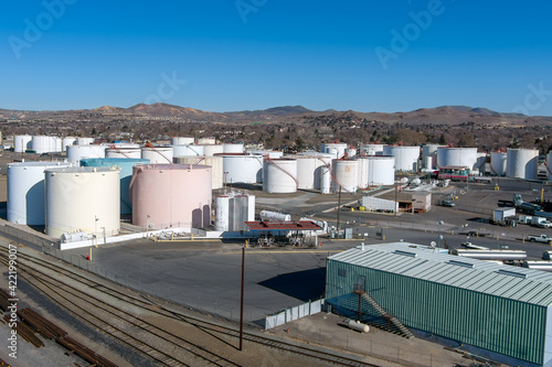 Aerial view of a Petroleum fuel storage tank farm near some railroad tracks. © gchapel