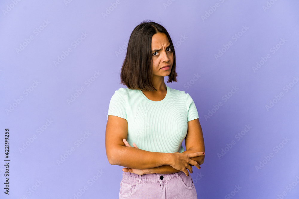 Young mixed race woman suspicious, uncertain, examining you. Young mixed race woman suspicious, uncertain, examining you.