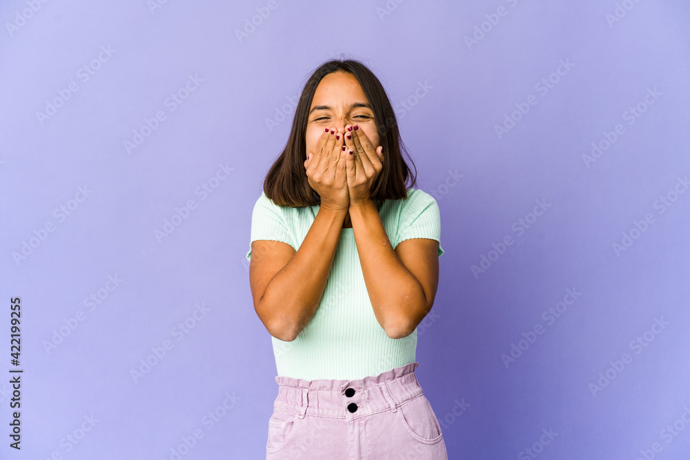Young mixed race woman laughing about something, covering mouth with hands. Young mixed race woman laughing about something, covering mouth with hands.